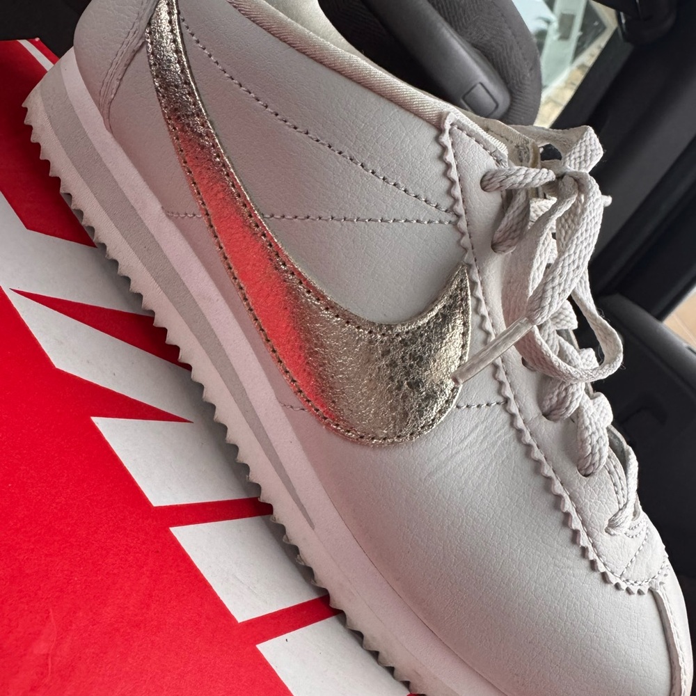 Nike Women's White Sneaker with Metallic Gold Swoosh